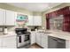 Clean kitchen with stainless steel appliances, white cabinets, and essential cookware at 7977 W Wacker Rd # 171, Peoria, AZ 85381