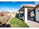 Landscaped backyard with a covered patio, grill, and well-maintained lawn at 808 E Constance Way, Phoenix, AZ 85042