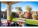 Beautiful backyard with covered patio, artificial grass, and mature landscaping at 808 E Constance Way, Phoenix, AZ 85042