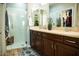 Bright bathroom with dual vanities, a glass-enclosed shower, and modern fixtures at 808 E Constance Way, Phoenix, AZ 85042