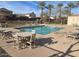 Sparkling community pool area, showcasing tables, lounge chairs and desert landscaping at 808 E Constance Way, Phoenix, AZ 85042