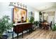 Cozy living room featuring unique wall decor, hardwood floors, and ample natural light at 808 E Constance Way, Phoenix, AZ 85042