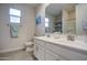 Bathroom with double sink vanity, picture window, and tile flooring at 8420 S 69Th Ln, Laveen, AZ 85339