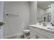 Neutral toned bathroom with a white single sink vanity, framed mirror, and a shower-tub combo at 8420 S 69Th Ln, Laveen, AZ 85339