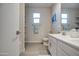 Double sink bathroom with picture window, and adjacent closet at 8420 S 69Th Ln, Laveen, AZ 85339
