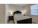 Comfortable bedroom with a dark wood frame bed, plush bedding and side tables with lamps at 8420 S 69Th Ln, Laveen, AZ 85339
