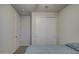 Calm bedroom featuring an ensuite bathroom, closet, and a plush blue comforter on the bed at 8420 S 69Th Ln, Laveen, AZ 85339
