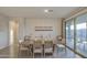 Dining room with modern decor, sliding door to patio and backyard at 8420 S 69Th Ln, Laveen, AZ 85339