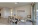 Modern dining room showcasing a large table, six chairs, and access to the backyard at 8420 S 69Th Ln, Laveen, AZ 85339