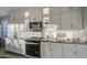 Kitchen with white cabinets, stainless steel appliances, and a gas range at 8420 S 69Th Ln, Laveen, AZ 85339