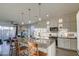 Modern kitchen with large island, stainless steel appliances, and open view to the living area at 8420 S 69Th Ln, Laveen, AZ 85339