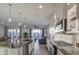 Open concept kitchen with a granite island, pendant lighting and stainless steel appliances at 8420 S 69Th Ln, Laveen, AZ 85339