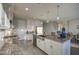 Modern kitchen boasts stainless steel appliances, a spacious island, and ample white cabinetry with granite countertops at 8420 S 69Th Ln, Laveen, AZ 85339