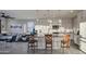 Kitchen area with barstool seating, stainless steel appliances, and white cabinetry at 8420 S 69Th Ln, Laveen, AZ 85339
