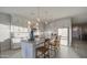 Bright and airy kitchen featuring a large central island, pendant lighting, and stylish tile flooring at 8420 S 69Th Ln, Laveen, AZ 85339