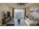 Cozy living room with a comfortable gray sectional, large window, and modern decor at 8420 S 69Th Ln, Laveen, AZ 85339