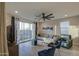 Inviting living room with a comfortable gray sectional, large window, and access to the backyard at 8420 S 69Th Ln, Laveen, AZ 85339