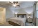 Cozy main bedroom with a ceiling fan, bedside lamps, and soft neutral tones at 8420 S 69Th Ln, Laveen, AZ 85339