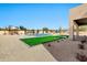 Desert landscaping with a modern pool and artificial turf create a beautiful backyard oasis at 8730 E Tether Trl, Scottsdale, AZ 85255