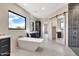Modern bathroom featuring a freestanding tub, dark cabinets, and a spacious walk-in shower with stylish tile at 8730 E Tether Trl, Scottsdale, AZ 85255