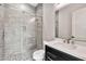 Modern bathroom featuring gray tile shower with glass door, dark vanity, and a modern faucet at 8730 E Tether Trl, Scottsdale, AZ 85255