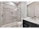 Modern bathroom featuring a subway tile shower with glass door, dark vanity, and bright countertop at 8730 E Tether Trl, Scottsdale, AZ 85255