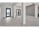 Spacious entryway with tile floors, modern doors, and clean lines, leading to the home's interior at 8730 E Tether Trl, Scottsdale, AZ 85255