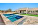 Backyard oasis with a modern pool and spa, travertine decking, and a view of the home's exterior at 8730 E Tether Trl, Scottsdale, AZ 85255