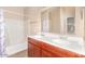 Bright bathroom featuring double sinks, a large mirror, and a tub/shower combo at 1017 E Odeum Ln, Phoenix, AZ 85040