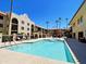 Enjoy the luxurious pool surrounded by beautiful buildings and palm trees at 10330 W Thunderbird Blvd # C128, Sun City, AZ 85351