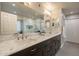 Modern bathroom with dual sinks, marble countertops, walk-in shower and contemporary fixtures at 10490 E Dreyfus E Ave, Scottsdale, AZ 85260