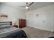 Comfortable bedroom with a ceiling fan, neutral colors and a cozy bed at 10490 E Dreyfus E Ave, Scottsdale, AZ 85260