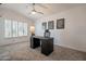 Bedroom with a ceiling fan, a desk area, and large shuttered windows at 10490 E Dreyfus E Ave, Scottsdale, AZ 85260