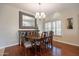 Charming dining room with wood flooring, elegant chandelier and large mirror at 10490 E Dreyfus E Ave, Scottsdale, AZ 85260