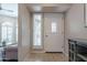 Bright entryway featuring tile flooring, a side window, and a white door with decorative glass panel at 10490 E Dreyfus E Ave, Scottsdale, AZ 85260
