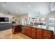Modern kitchen seamlessly connects to the living room, offering a granite countertop and stainless appliances at 10490 E Dreyfus E Ave, Scottsdale, AZ 85260