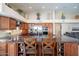 Expansive kitchen with an oversized island, seating, modern appliances, and custom wood cabinets at 10490 E Dreyfus E Ave, Scottsdale, AZ 85260