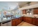 Bright kitchen with stainless appliances, granite countertops, and views of the pool from the breakfast nook at 10490 E Dreyfus E Ave, Scottsdale, AZ 85260