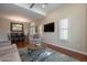 Open living room with wood floors, plantation shutters, and view to the dining room at 10490 E Dreyfus E Ave, Scottsdale, AZ 85260