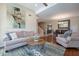 Spacious living room featuring hardwood floors, a decorative rug, and an open layout leading to the dining area at 10490 E Dreyfus E Ave, Scottsdale, AZ 85260