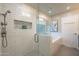 Beautiful main bathroom featuring a glass shower, soaking tub, and neutral colored finishes at 10490 E Dreyfus E Ave, Scottsdale, AZ 85260