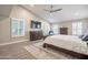 Bright main bedroom with ensuite bathroom, ceiling fan, and wood-look floors at 10490 E Dreyfus E Ave, Scottsdale, AZ 85260