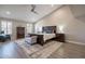 Spacious main bedroom featuring a ceiling fan, natural lighting, and wood-look floors at 10490 E Dreyfus E Ave, Scottsdale, AZ 85260