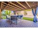 Covered patio with outdoor seating, a well-maintained lawn, and a glimpse of the inviting pool area at 10490 E Dreyfus E Ave, Scottsdale, AZ 85260