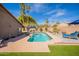 Beautiful swimming pool with a lounge chair in a well-landscaped backyard at 10490 E Dreyfus E Ave, Scottsdale, AZ 85260