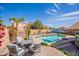 Inviting backyard features a sparkling pool, lounge chairs, and outdoor seating, perfect for relaxing and entertaining at 10490 E Dreyfus E Ave, Scottsdale, AZ 85260