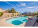 Sparkling swimming pool surrounded by lush landscaping, offering a private backyard oasis at 10490 E Dreyfus E Ave, Scottsdale, AZ 85260