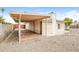 View of the backyard featuring a covered patio with brick flooring and gravel landscaping at 10822 N 47Th Ave, Glendale, AZ 85304