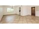 Bright living room with tile flooring and an open floorplan with sightlines to the kitchen at 10822 N 47Th Ave, Glendale, AZ 85304