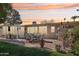 Spacious backyard patio with outdoor dining set, screened in patio, and a lush lawn area at 11011 N Coggins Dr, Sun City, AZ 85351